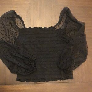 Black Anthropologie touched top with sheer polka dot sleeves